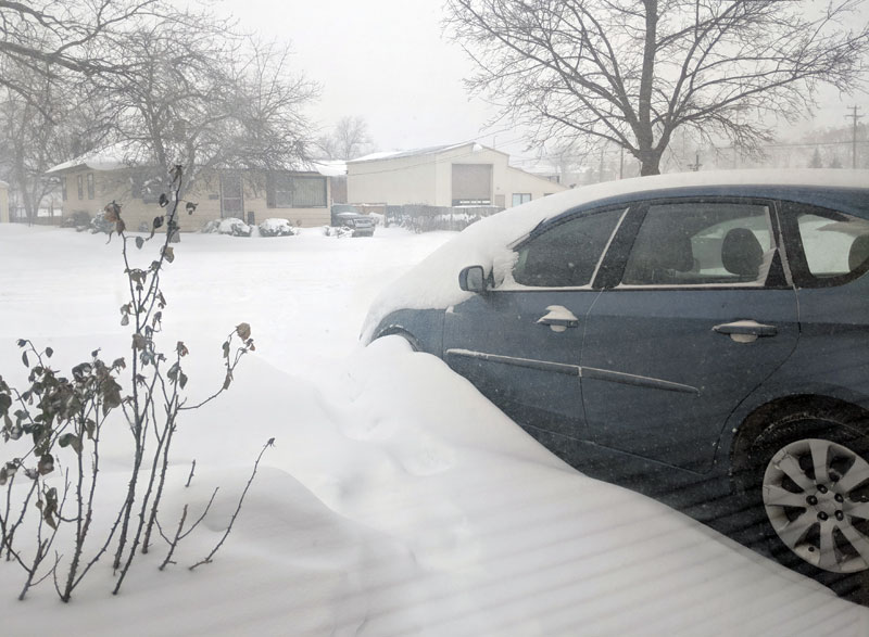 Subaru covered in a blizzard snow drift
