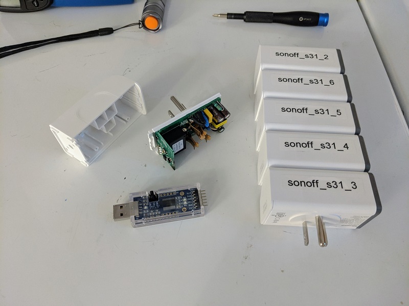 Sonoff S31 plugs alongside a USB to serial adapter