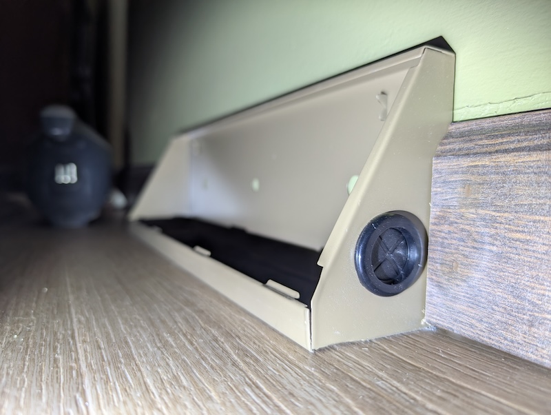 Baseboard register with wiring grommet installed